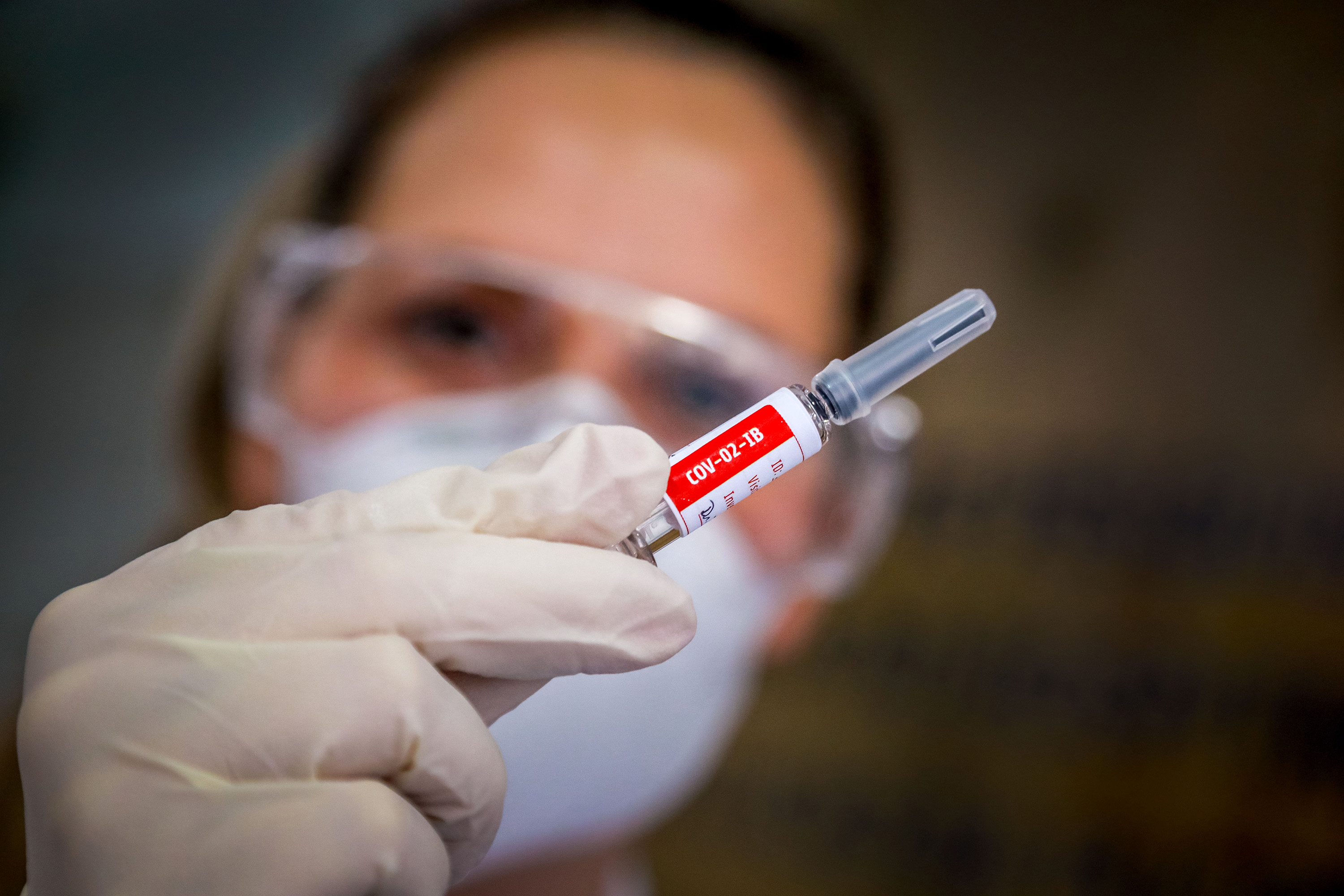 A nurse holds a COVID-19 vaccine produced by Chinese company Sinovac Biotech.