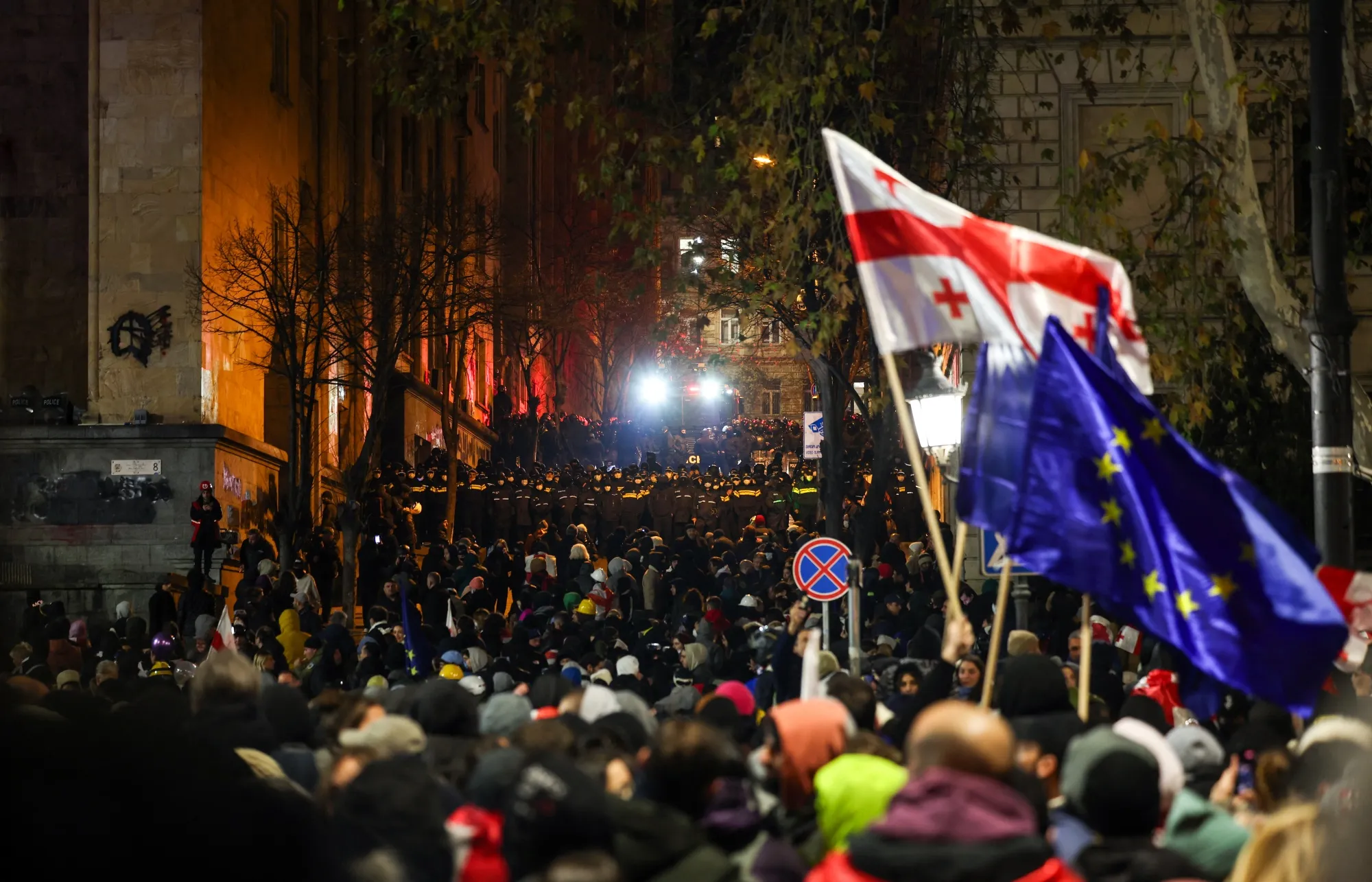 Police forces outside the parliament building as protesters rally for the fifth straight night against the government's postponement of EU accession talks until 2028, in central Tbilisi, on December 2.