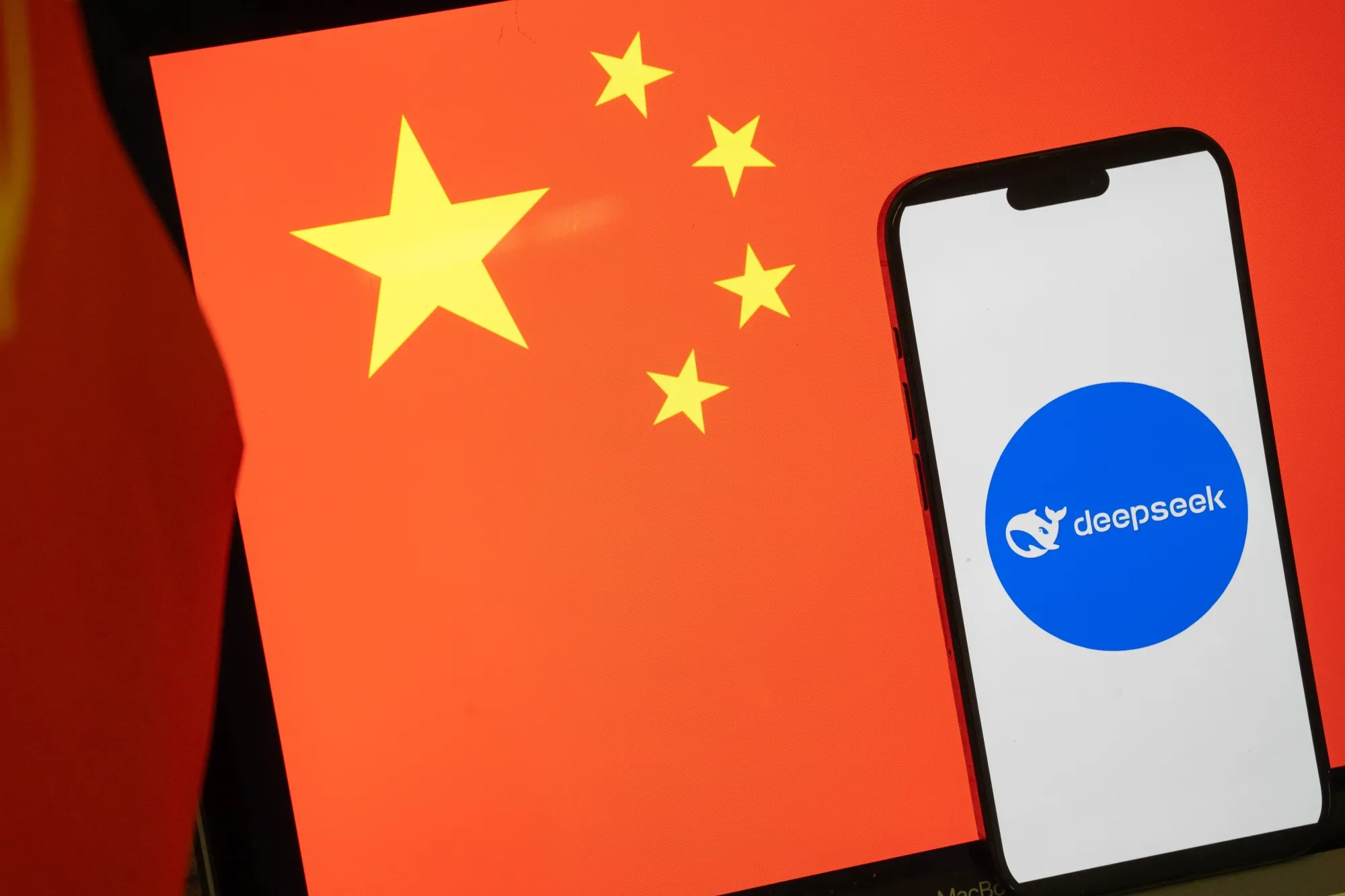 The logo for the DeepSeek AI service in front of a Chinese flag.