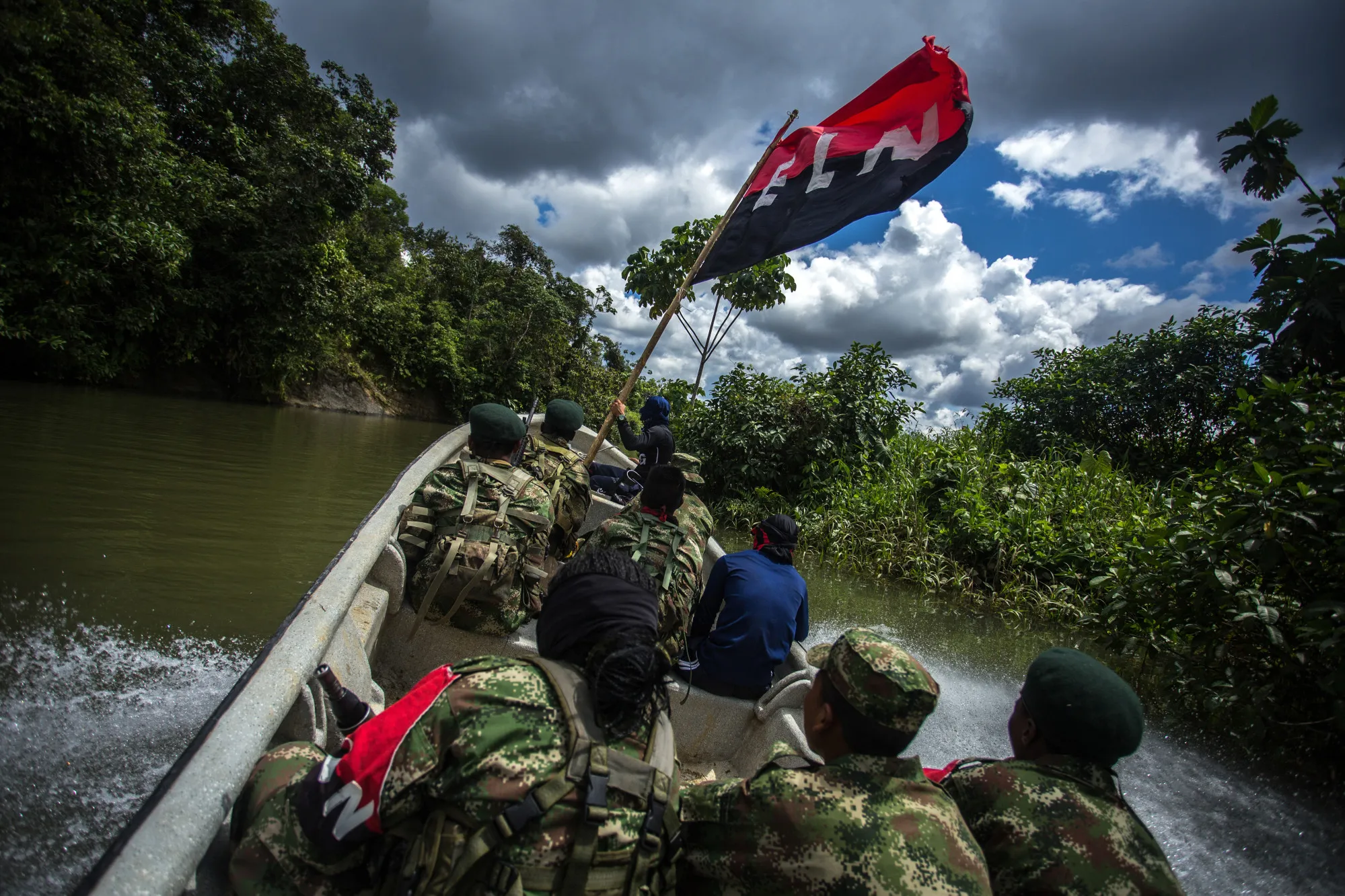 ELN guerrillas patrol a river