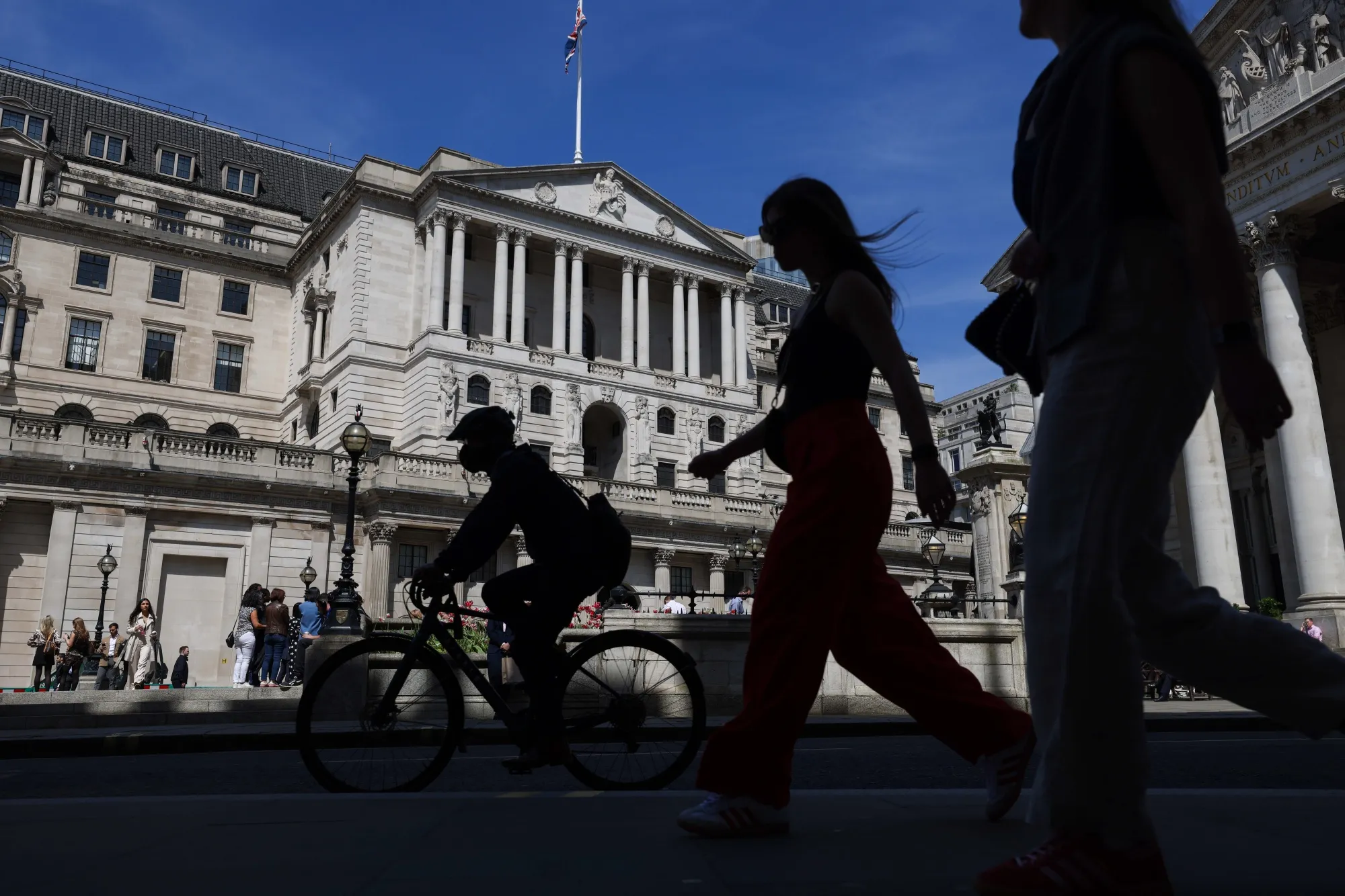 Commuters pass the Bank of England in London.