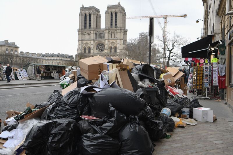 Trash piles up in the streets near Notre Dame Cathedral in Paris. 