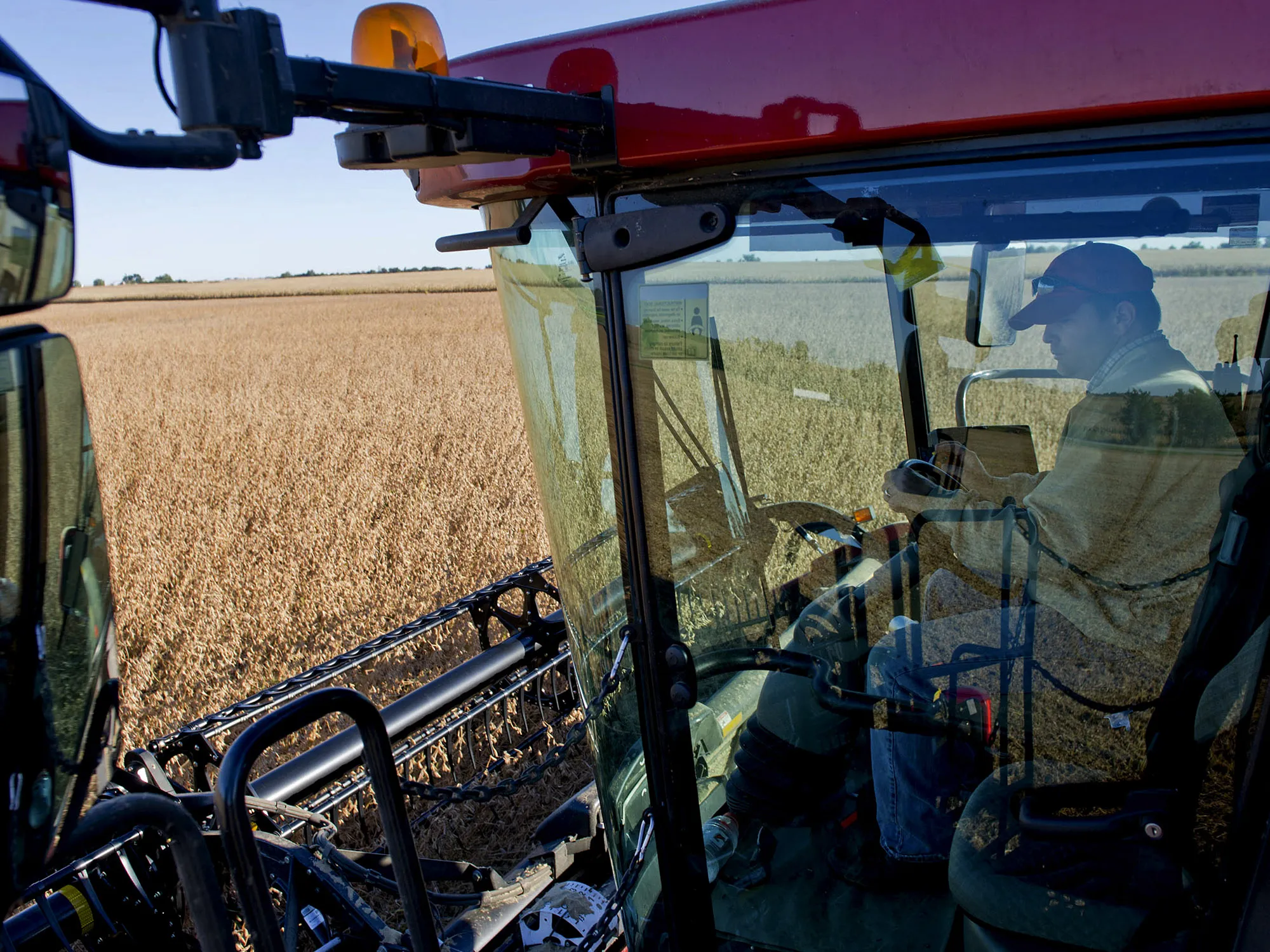 A man operates a Case 7010 combine harvester as he harvests soybeans near Princeton, Illinois.&nbsp;