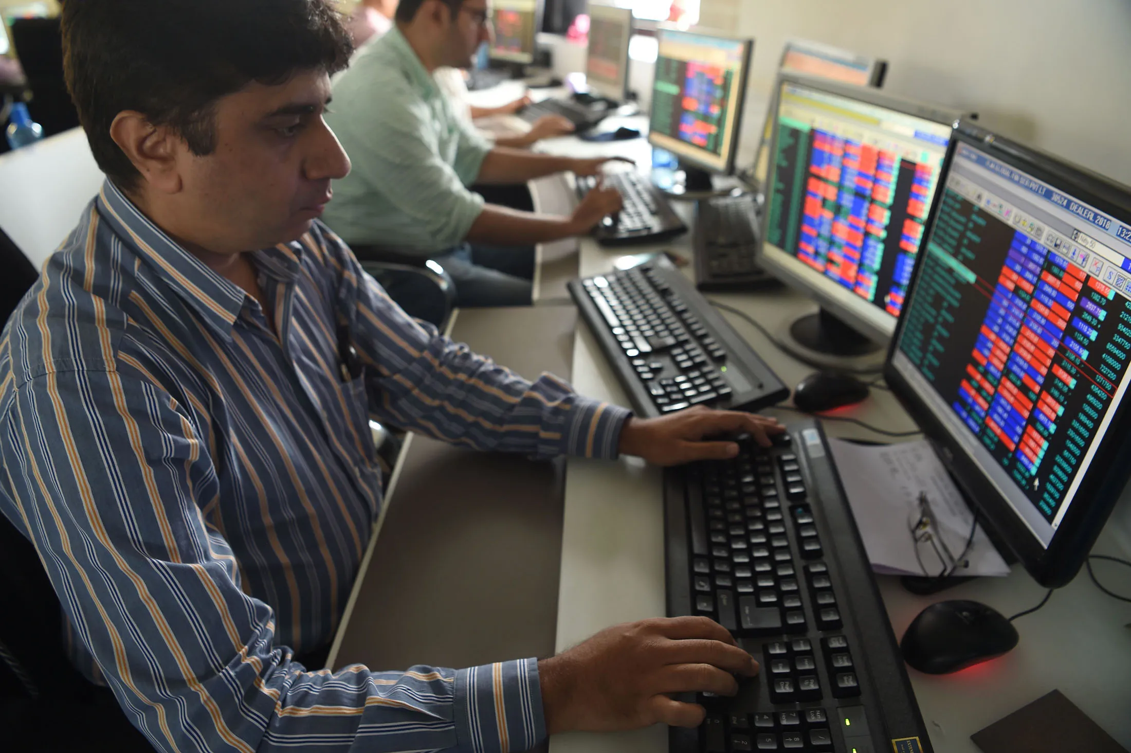 A stock trader watches share prices on his screen at a brokerage house in Mumbai on July 26, 2018. - Asian stocks mostly fell on July 26 as investor relief at US President Donald Trump and the European Commission chief's plan to ease trade tensions was offset by disappointing Wall Street earnings. (Photo by INDRANIL MUKHERJEE / AFP) (Photo credit should read INDRANIL MUKHERJEE/AFP/Getty Images)
