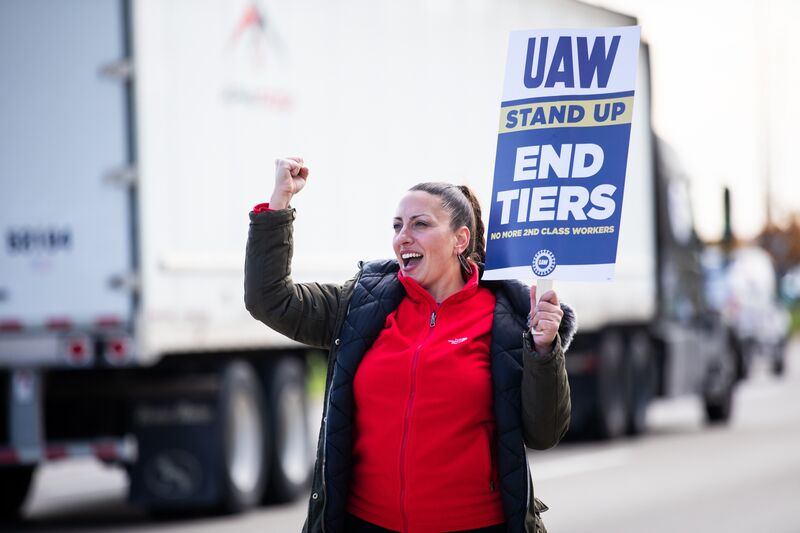 A United Auto Workers (UAW) sign held on a picket line outside the Stellantis Sterling Heights Assembly Plant in Sterling Heights, Michigan, US, on Monday, Oct. 23, 2023.