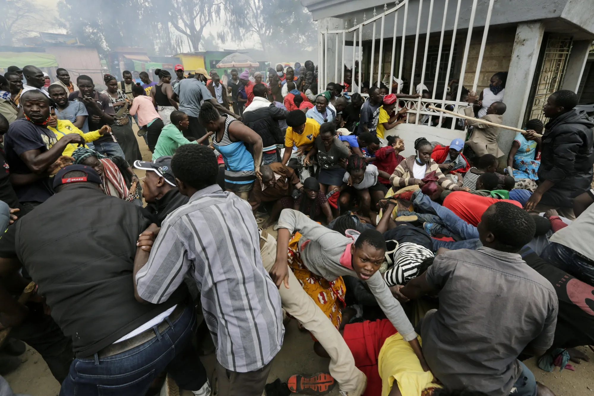 People&nbsp;push through a gate and create a stampede in the Kibera slum of Nairobi on April 10.