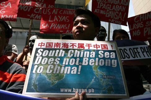 Protesters holding posters against China's incursions in the