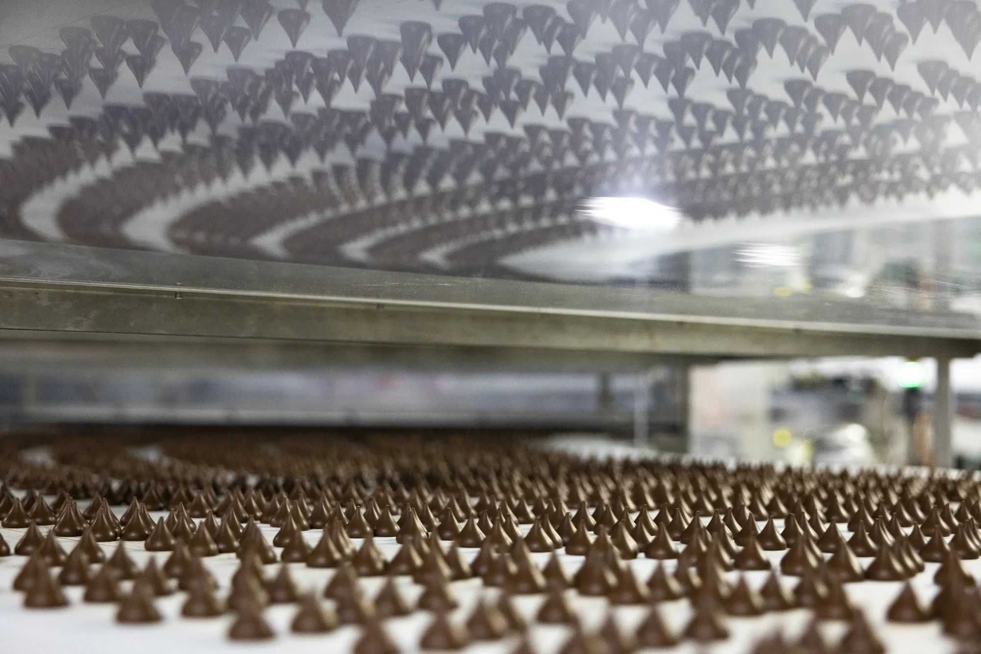 Hershey Kisses chocolate candies move along a conveyor at the company's factory in Hershey, Penn.