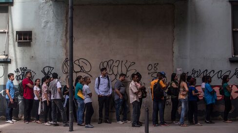 Job seekers wait in line at an employment fair in Rio de Janeiro, Brazil.