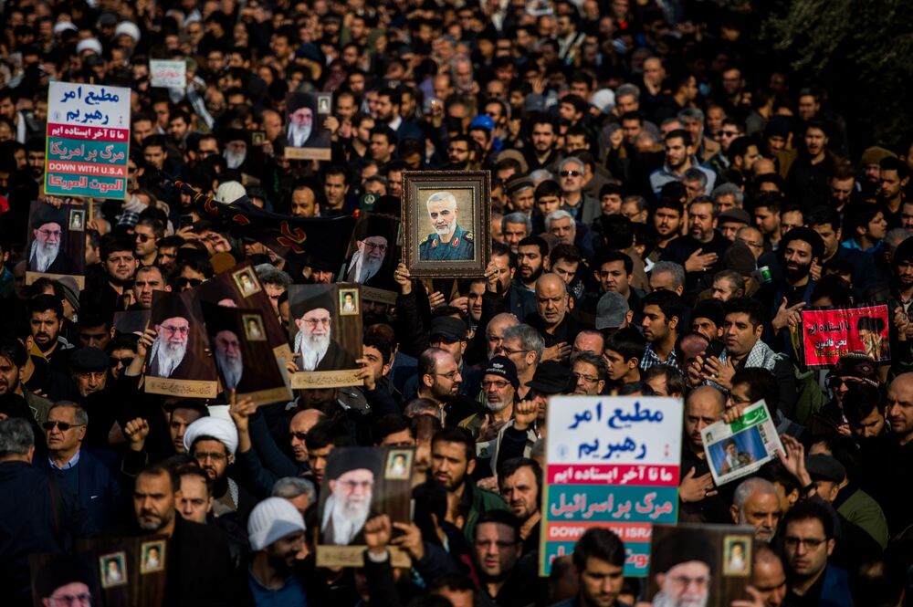 Protesters hold up an image of Qassem Soleimani, an Iranian commander, during a demonstration following the U.S. airstrike in Iraq which killed him, in Tehran, Iran,.