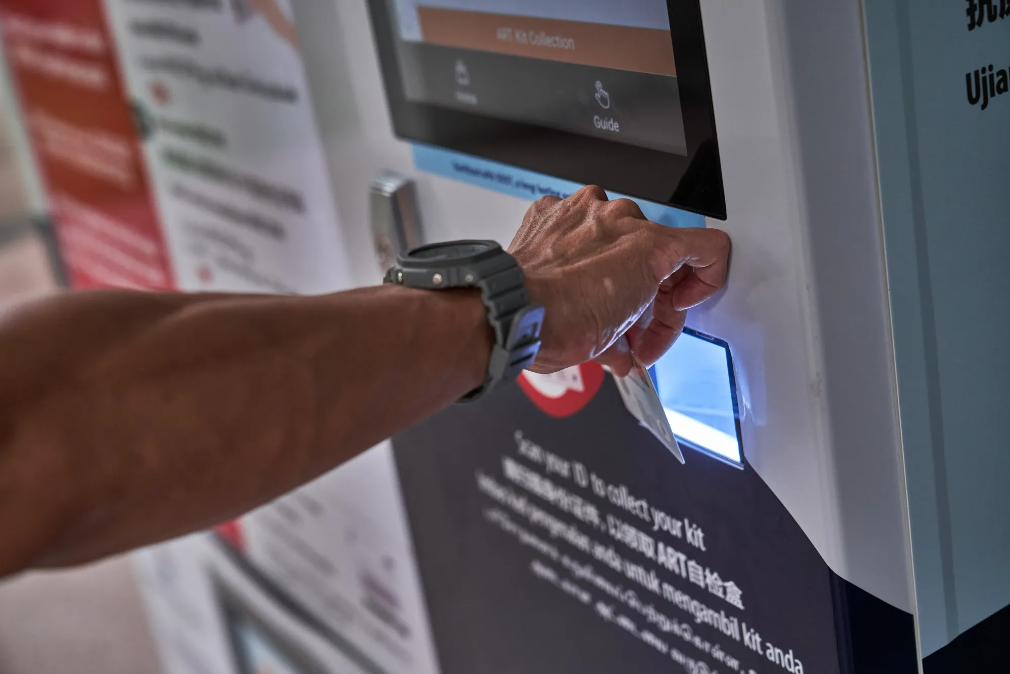 A customer purchases an Antigen Rapid Testing (ART) Self-Test Kit from a vending machine in Singapore.