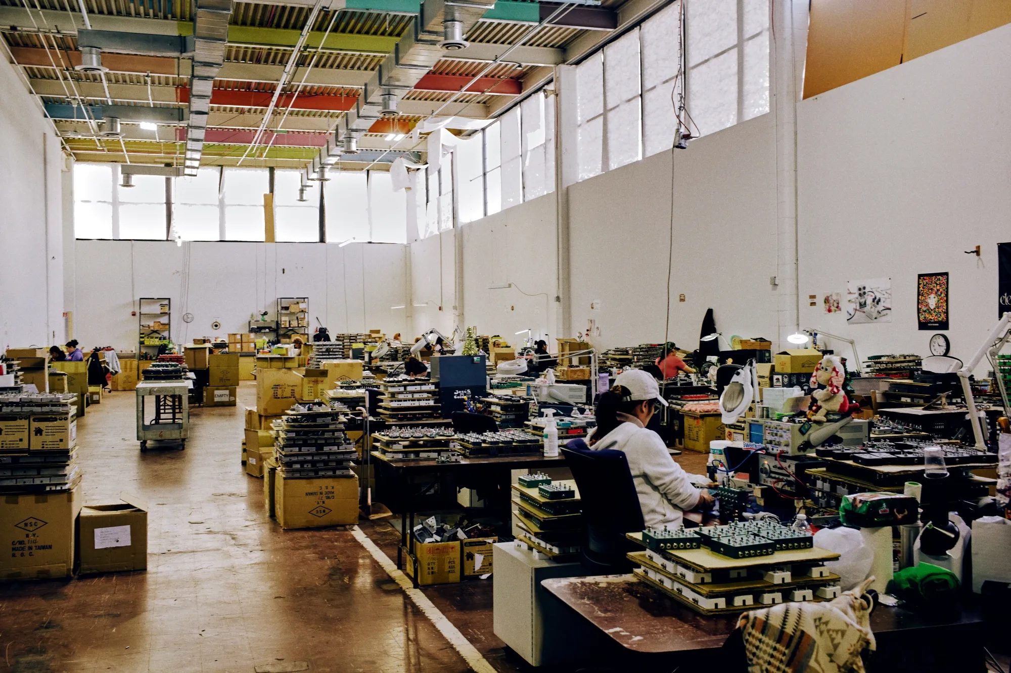 Workers assemble guitar pedals at Electro-Harmonix’s manufacturing facility in New York, on March 6.