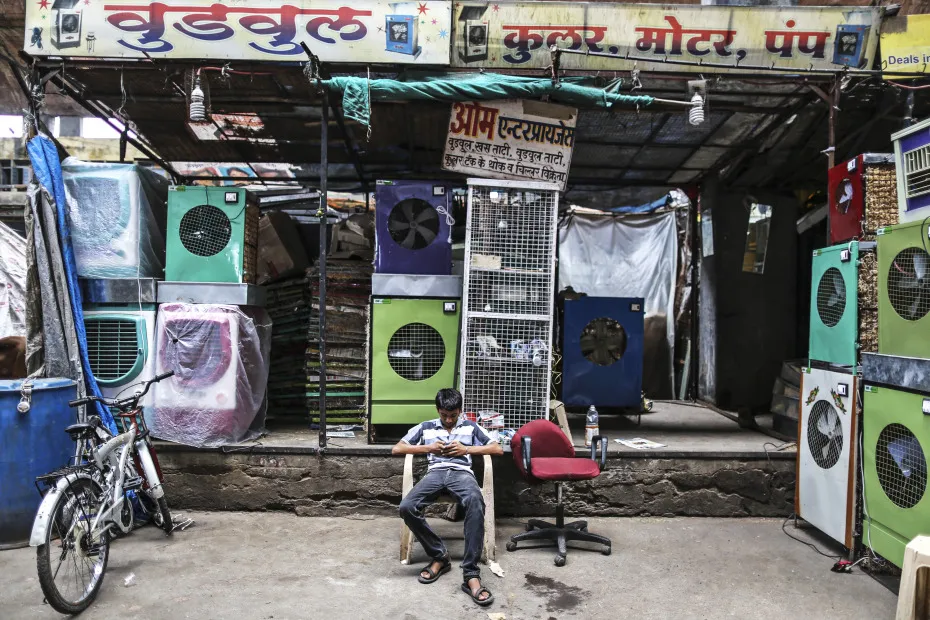 A vendor waits for customers outside a store selling air-conditioning units in Nagpur, India.
