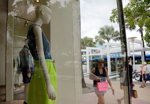Shoppers walk past a J. Crew retail store along Lincoln Road Mall in Miami Beach, Fla. on March 13.