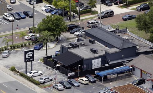 Law enforcement officials work at the scene of the Pulse Orlando nightclub in Orlando.