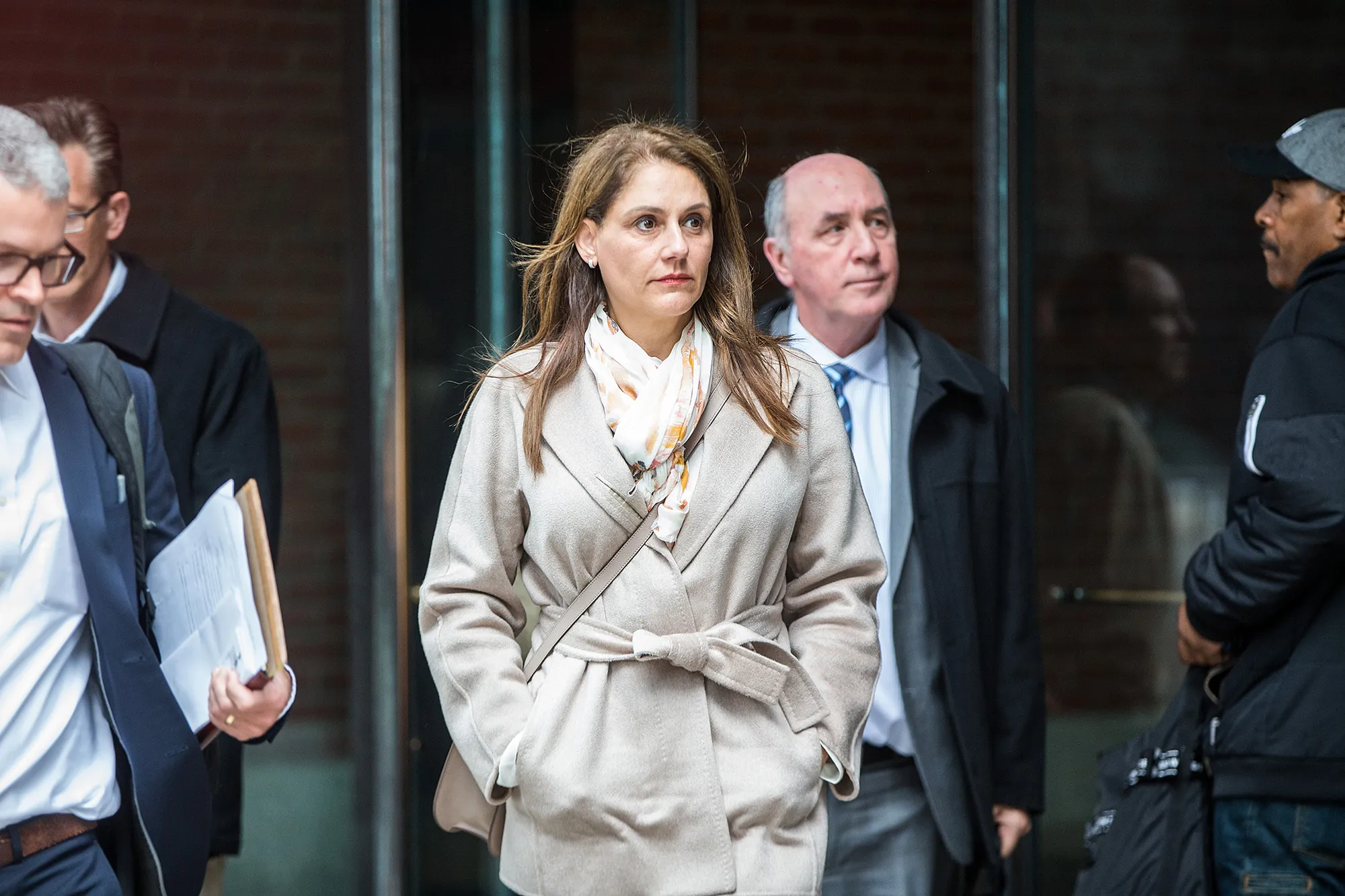 Michelle Janavs, center, exits federal court in Boston in 2019.