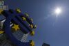 The sun shines on the euro sign sculpture outside the former European Central Bank (ECB) headquarters in Frankfurt, Germany, on Friday, June 28, 2019. Europeans fought to stay cool as a blast of hot air from the Sahara desert sent temperatures to records in large parts of the continent and whipped up concern about climate change.