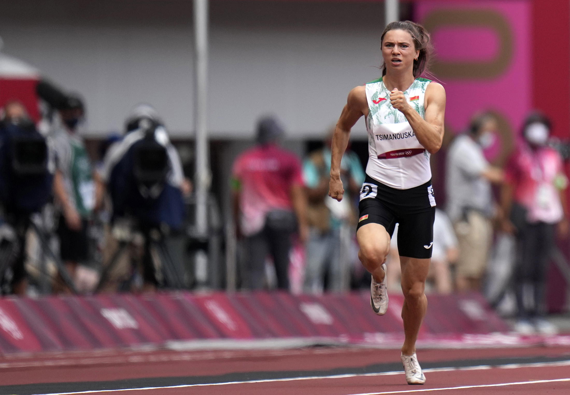 Krystsina Tsimanouskaya runs in the women's 100-meter run at the Tokyo Olympics on July 30.