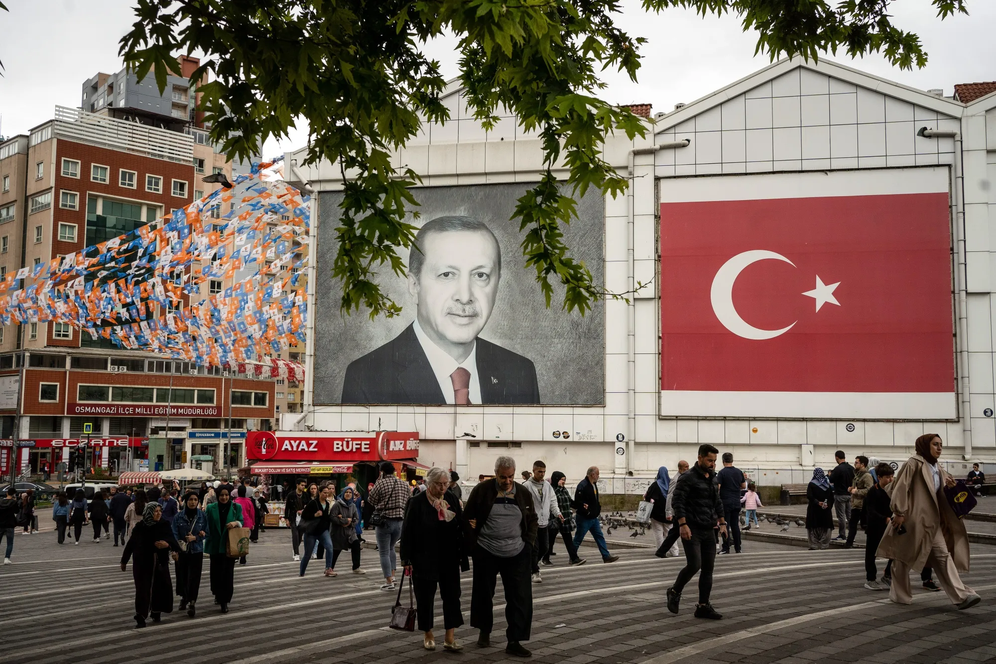 Pedestrians pass by a mural of Turkish President Recep Erdogan in Bursa, Turkey, on Thursday, May 18, 2023.