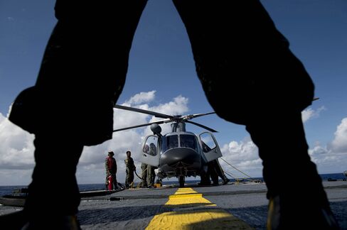 A Philippine Navy officer stands in front of a helicopter during a bilateral maritime exercise between the Philippine Navy and U.S. Navy.