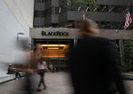 Pedestrians walk past BlackRock Inc. headquarters in New York, U.S, on Wednesday, June 11, 2018.