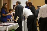 Job seekers speak with prospective employers during a career fair event in Los Angeles, on June 22, 2016.
