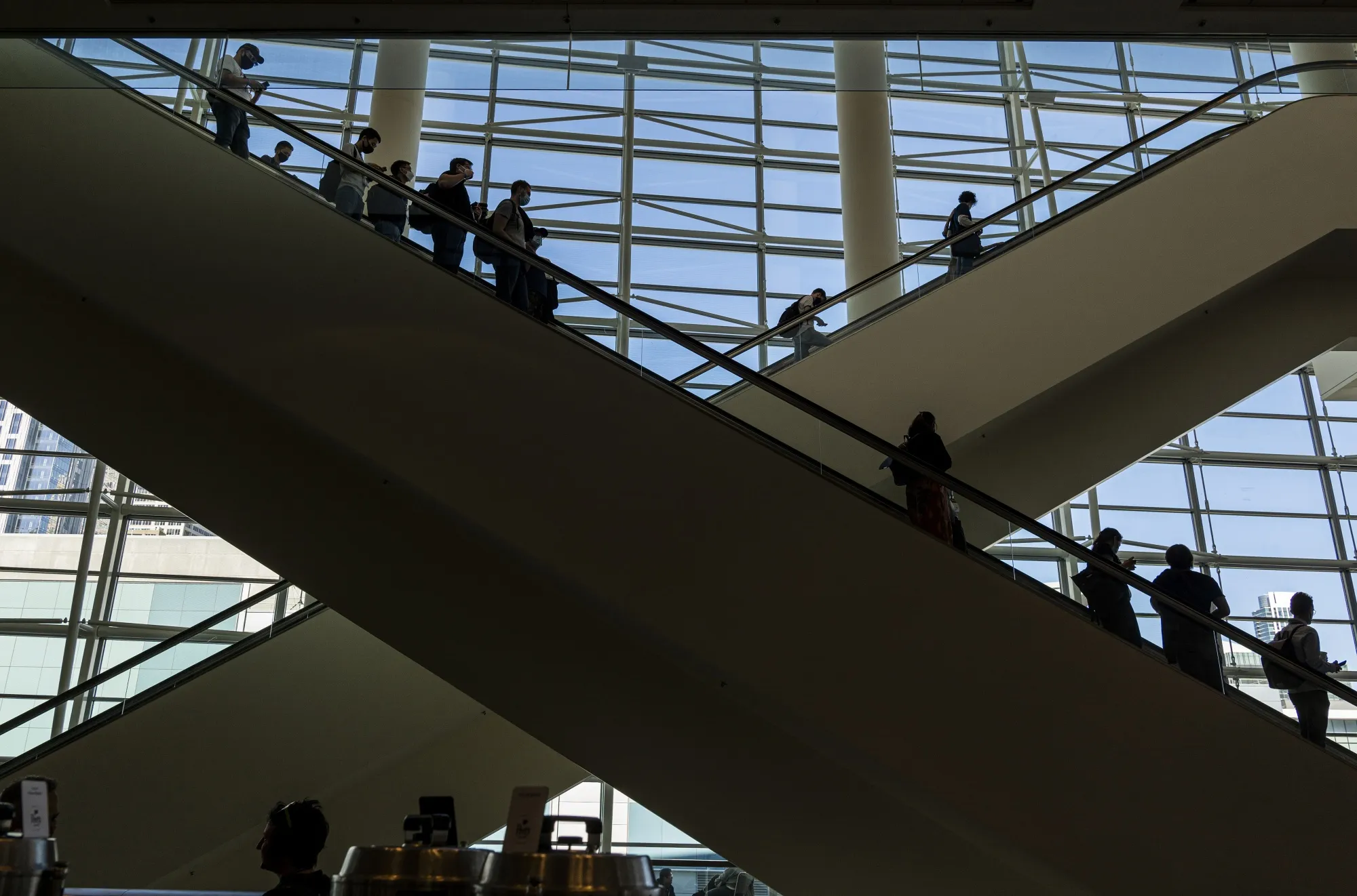 Attendees ride an escalator inside an exhibition hall during the Game Developers Conference at the Moscone Center in San Francisco in 2022.