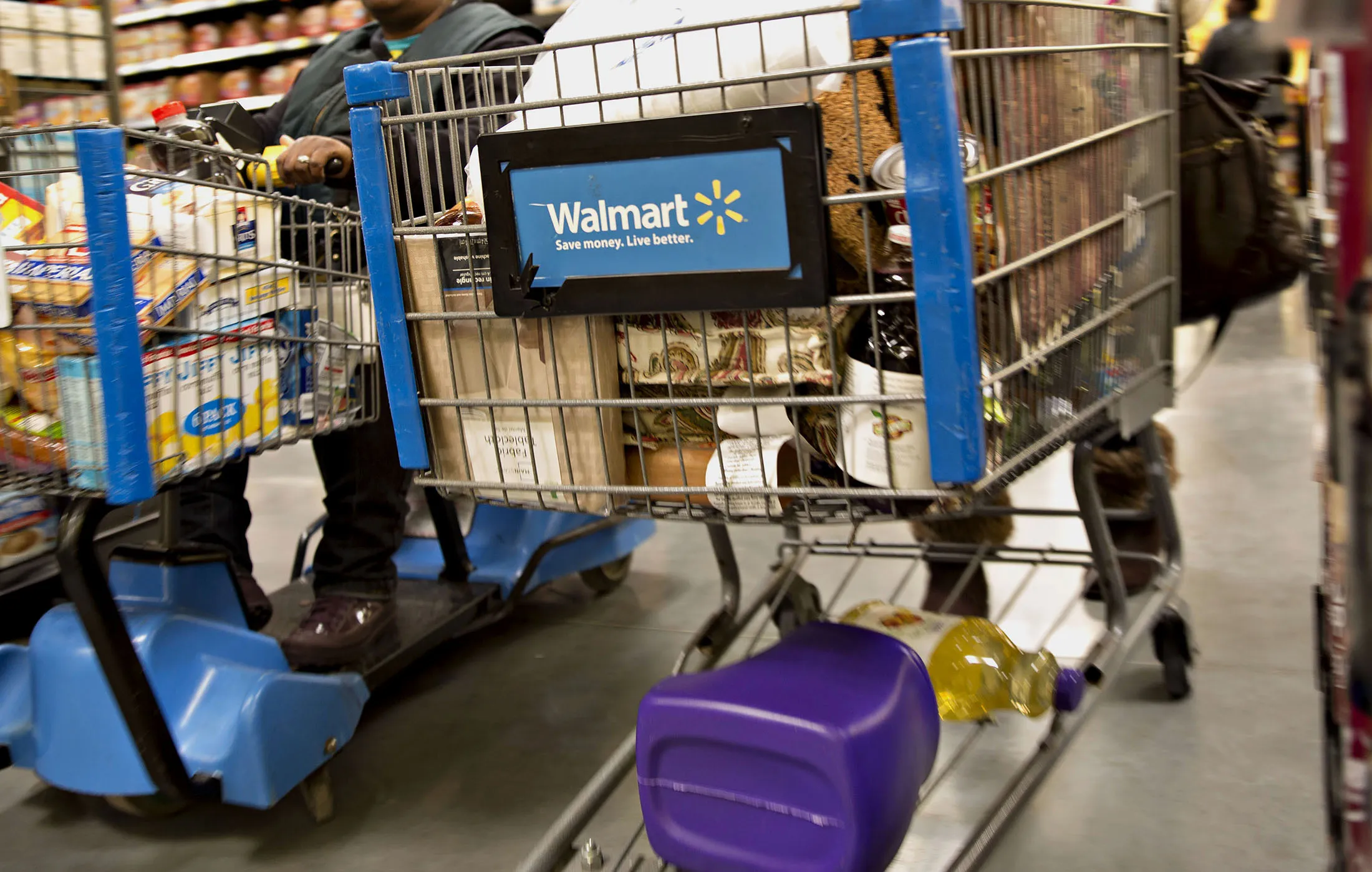 Shoppers push carts through the grocery department at a Wal-Mart Stores Inc. location in Chicago, Illinois, U.S., on Wednesday, Nov. 25, 2015.