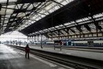 A SNCF employee walks on an empty platform of the Gare de Lyon train station in Paris.