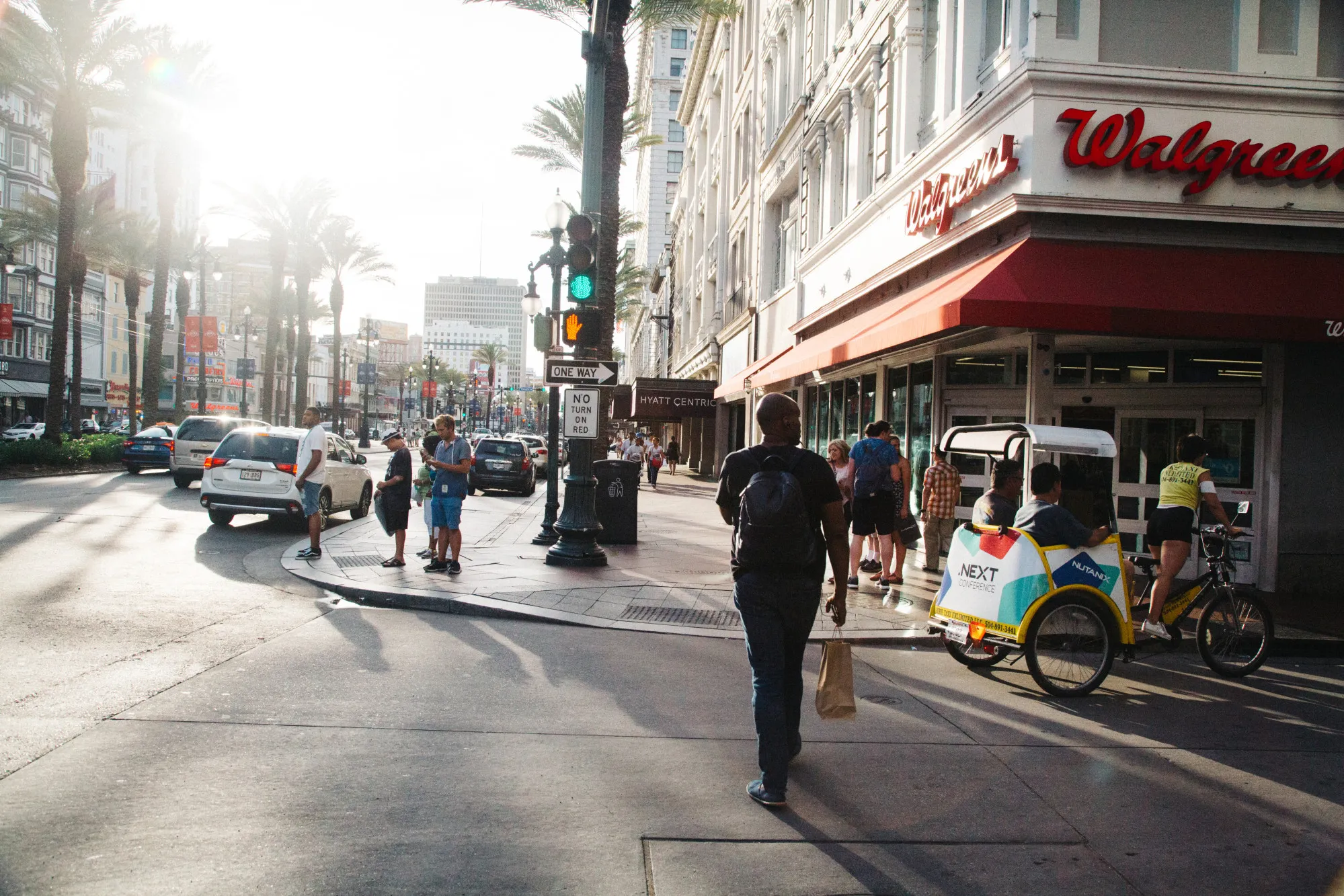 Pedestrians pass in front of a Walgreens.