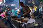 A street vendor makes food in the El Hueco neighborhood of Medellin, Colombia