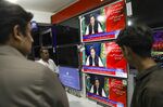 People watch a television broadcast&nbsp;of Imran Khan, in Rawalpindi, Pakistan.
