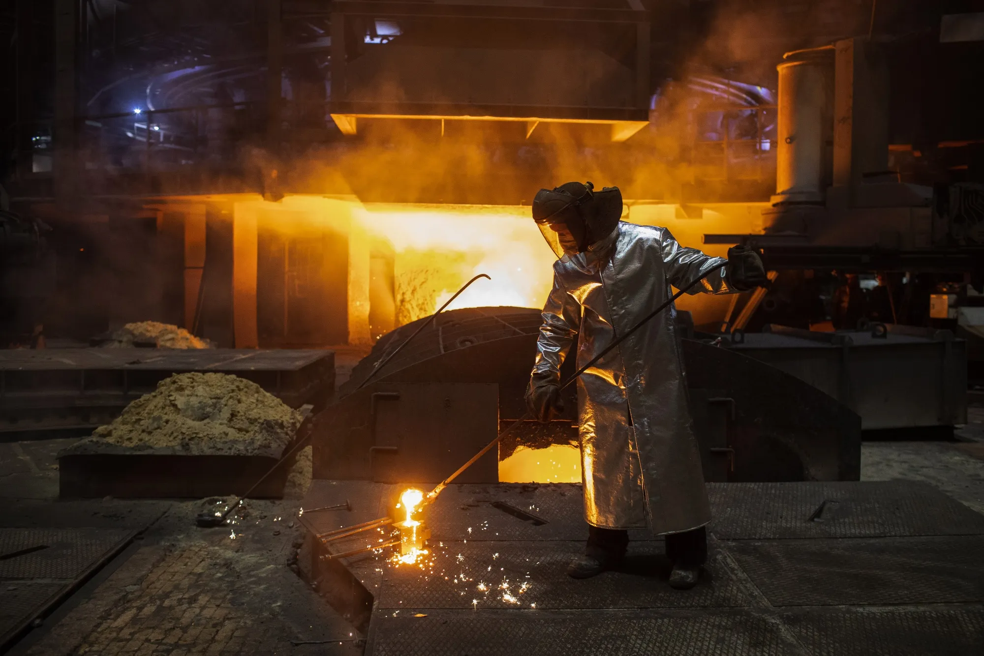 A worker uses a ladle to collect a sample of molten steel from the blast furnace at a steel mill&nbsp;in Cherepovets, Russia.