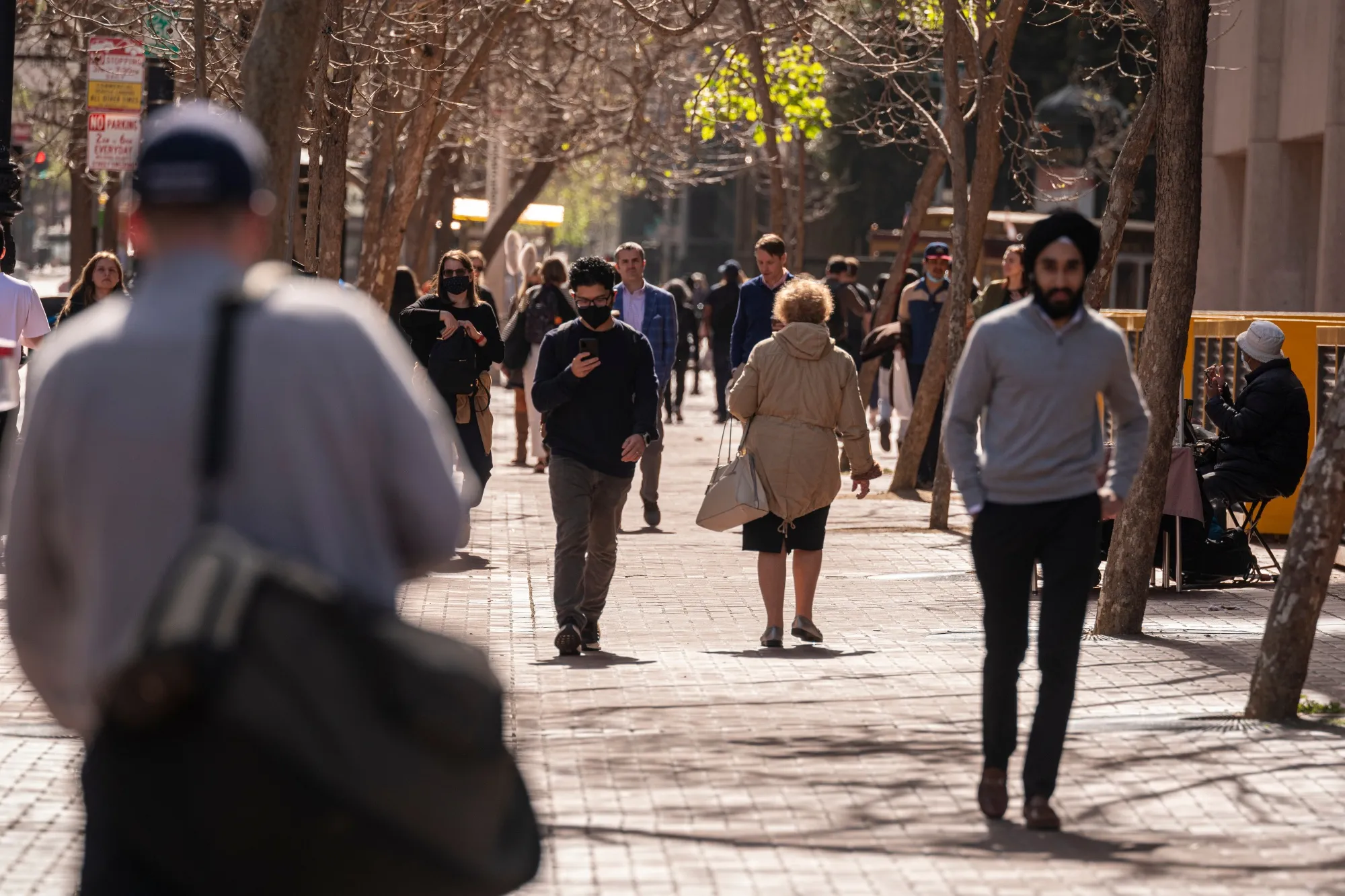 Pedestrians on Market Street in San Francisco in March 2022. Migration from the city has slowed to less than the pre-pandemic rate.