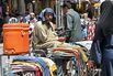A clothes vendor covers his head at a market in Rawalpindi, Pakistan, on April 22.