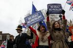 Pro-Brexit demonstrators hold &quot;No Deal? No Problem!&quot; placards near the Houses of Parliament in London on Jan. 15, 2019.