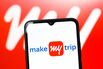 In this photo illustration, the MakeMyTrip Limited logo is