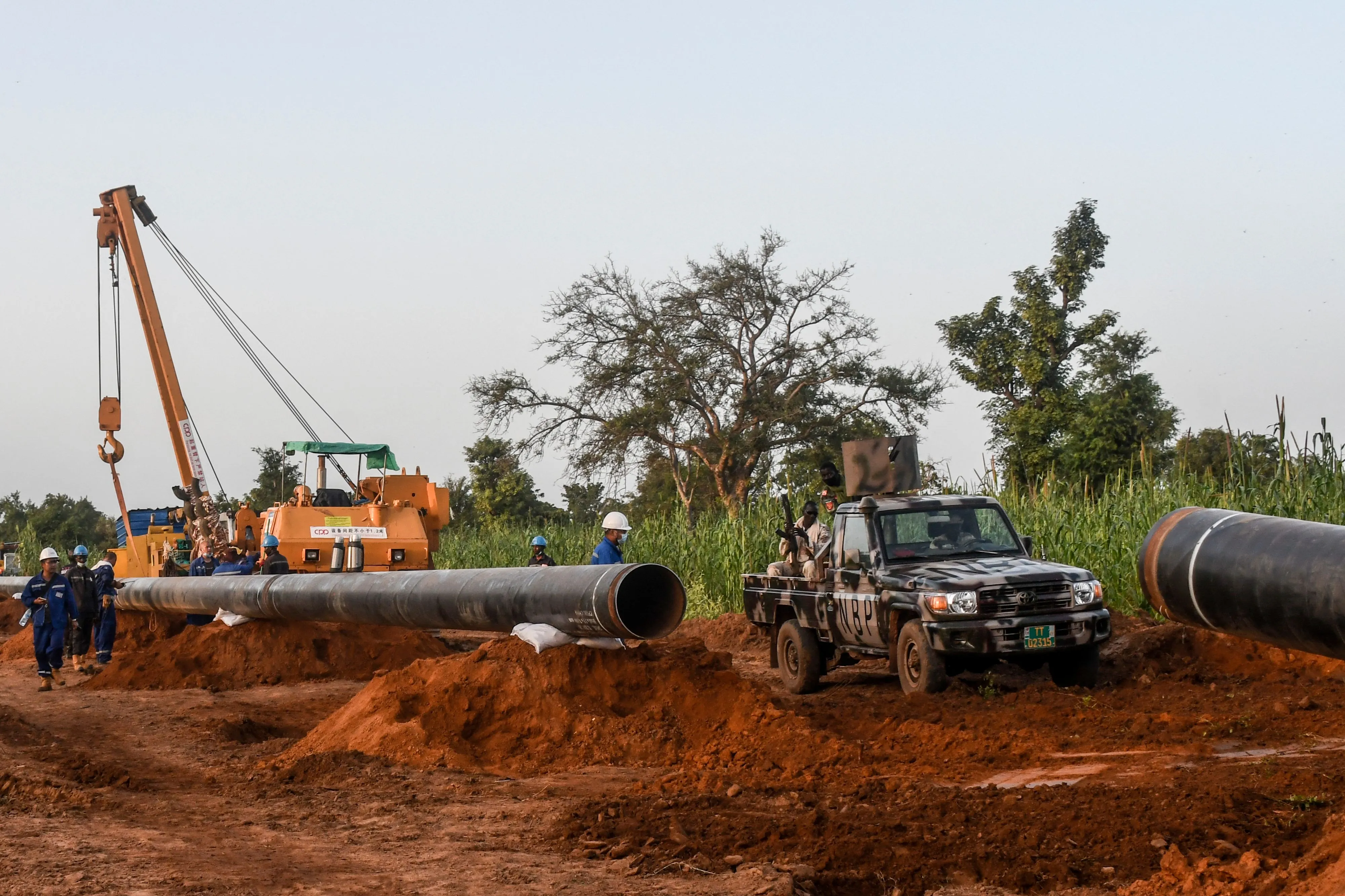 Workers from Niger and China are seen on the construction site of an oil pipeline in the region of Gaya, Niger.