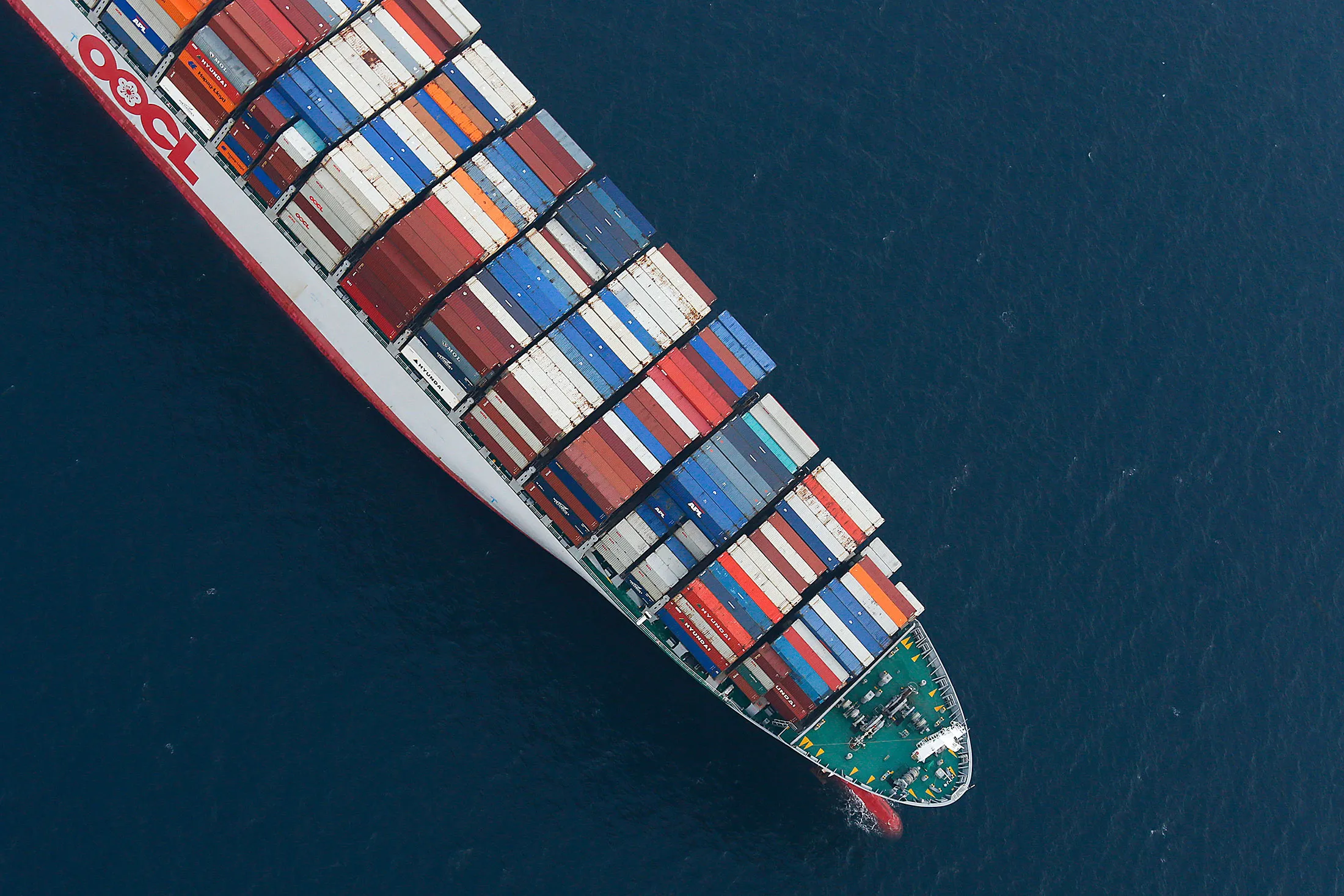 An Orient Overseas Container Line (OOCL) container ship waits to unload cargo in this aerial photograph taken above the Port of Los Angeles.
