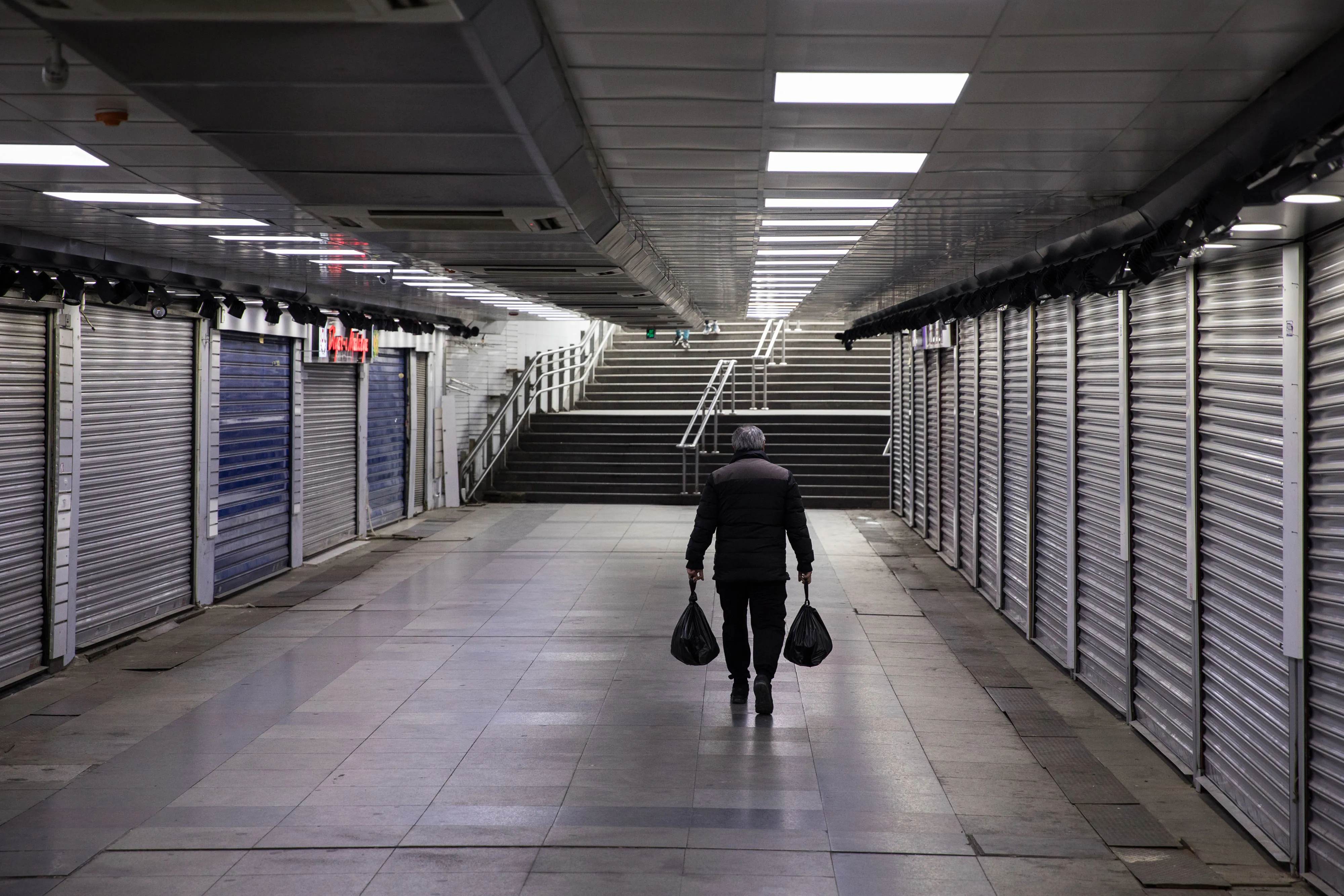 A pedestrian passes retail stores closed to prevent the spread of coronavirus in the Eminonu district of Istanbul on March 25.