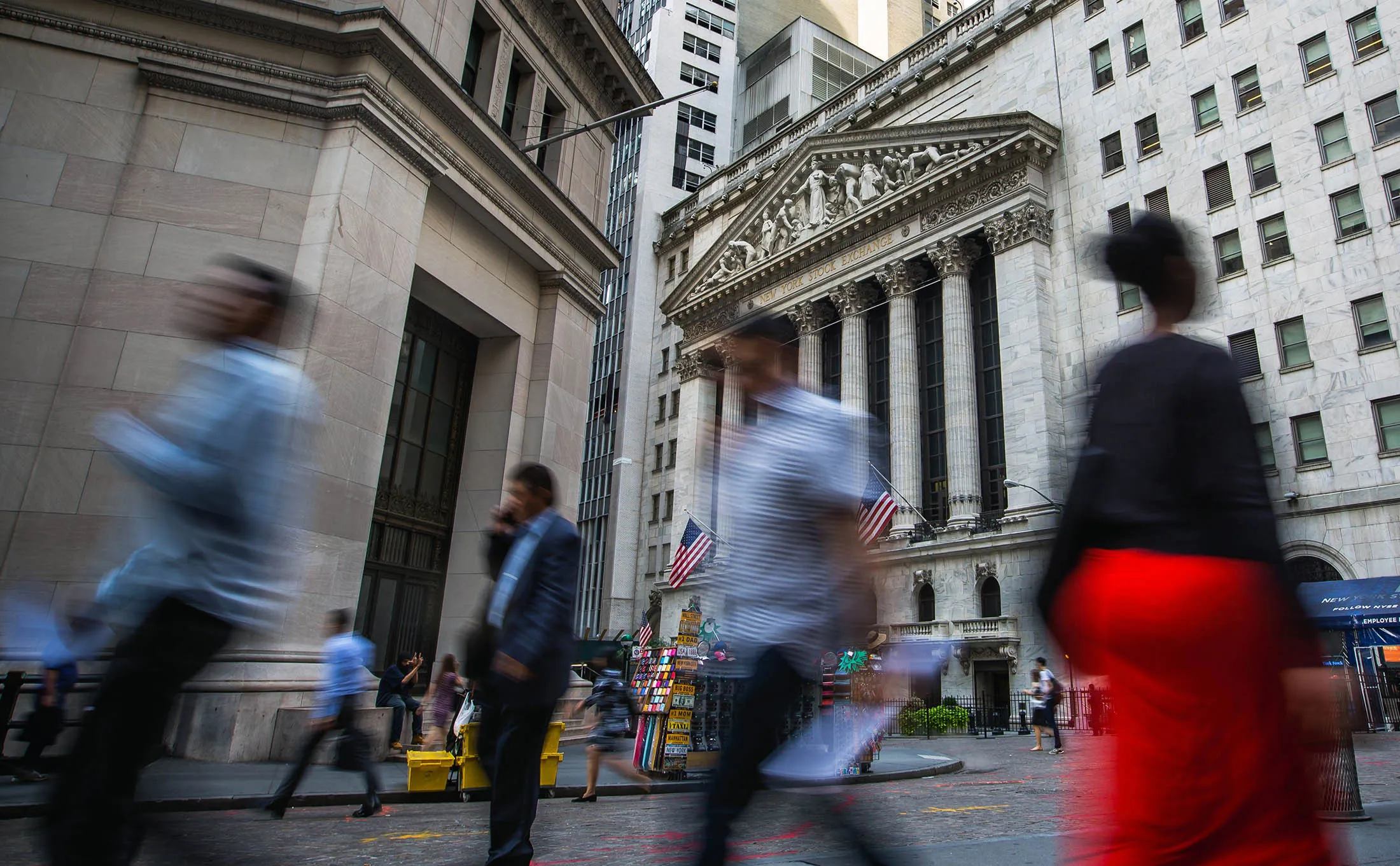 Pedestrians walk near the NYSE