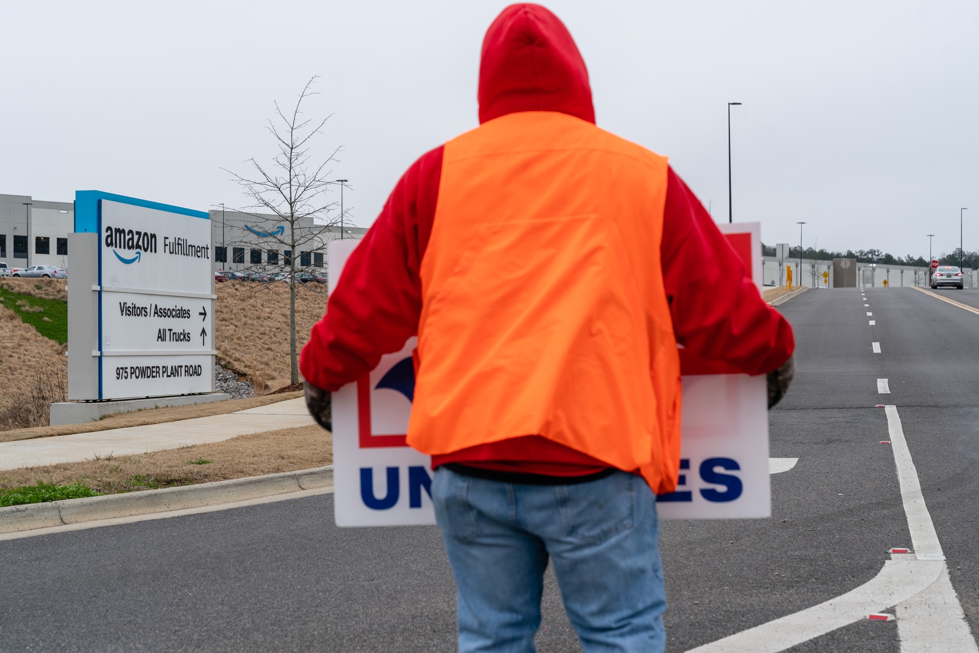 A demonstrator holds a sign during a Retail, Wholesale and Department Store Union (RWDSU) protest outside the Amazon BHM1 Fulfillment Center in Bessemer, Alabama, on&nbsp;Feb. 6.
