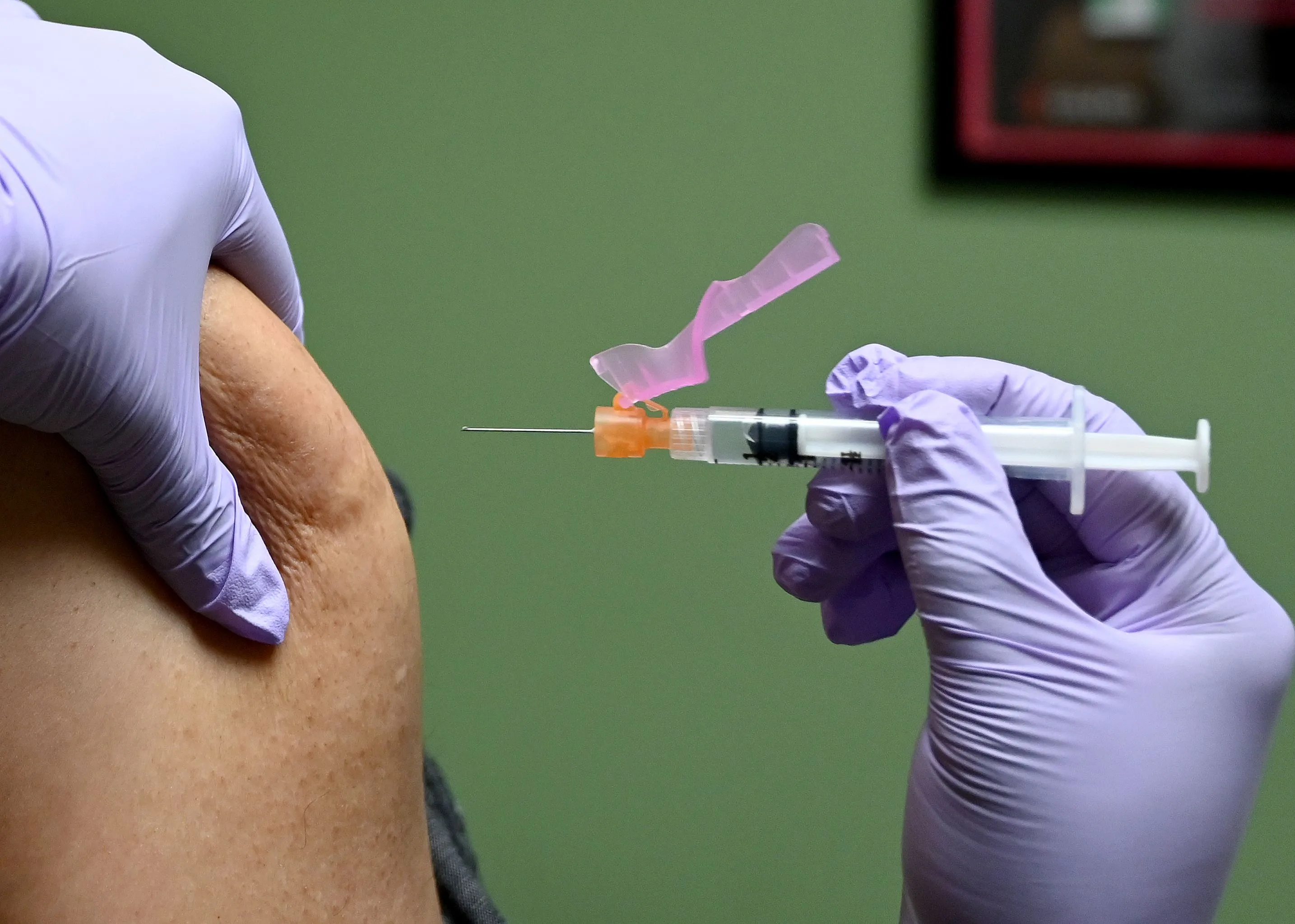 A patient gets a flu shot at a health facility in Washington.