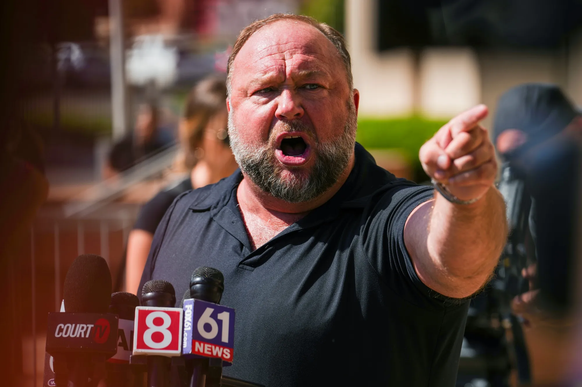 Alex Jones speaks to the media outside Waterbury Superior Court during his trial in Waterbury, Conn., on Sept. 21.