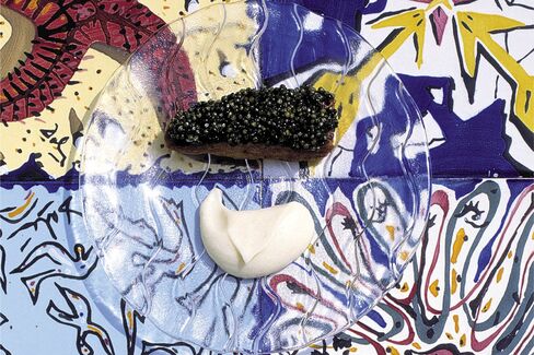 Adrià's Bone Marrow with Caviar, set against a Salvador Dalí tile.