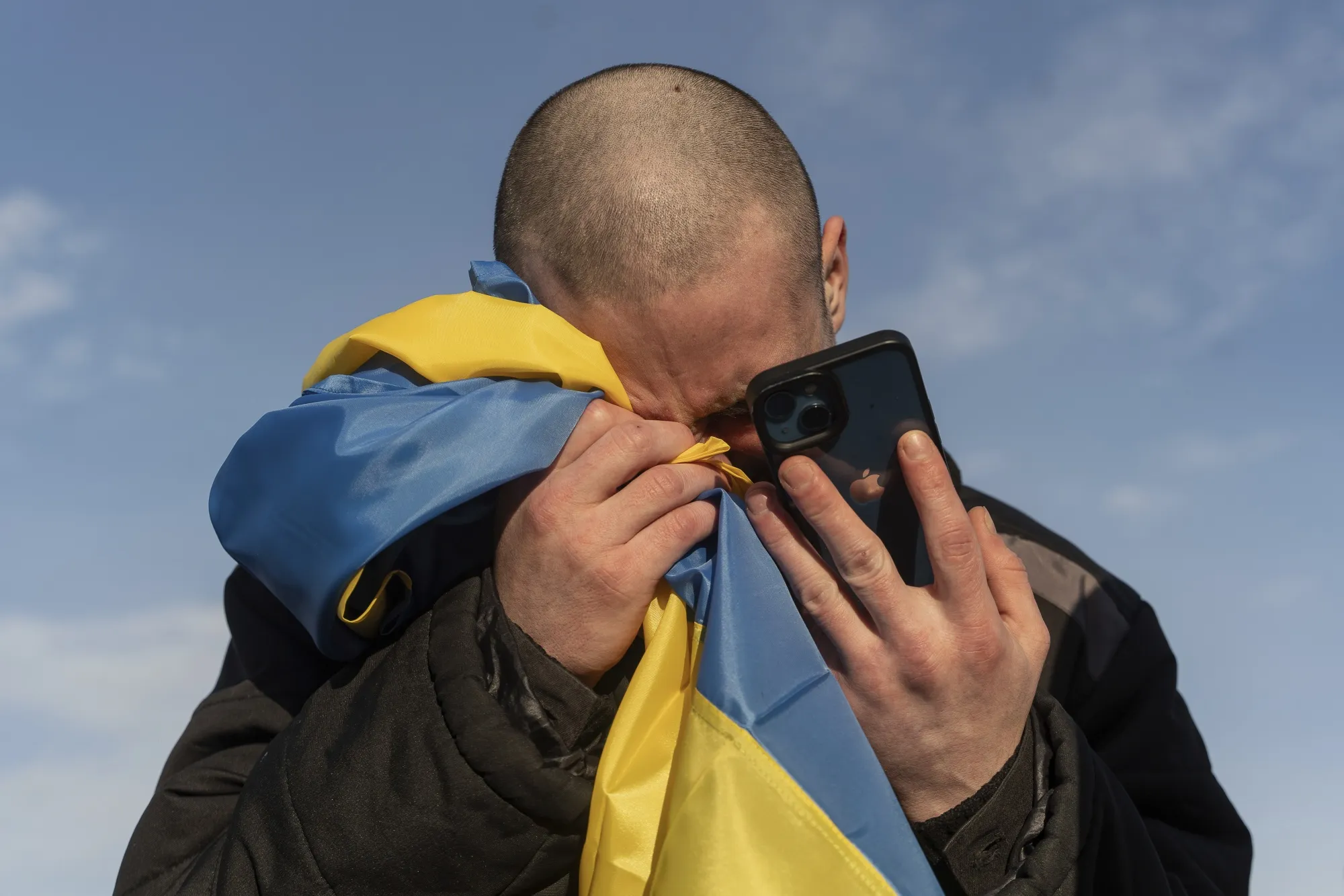 An Ukrainian prisoner of war cries while calling his relatives at an earlier prisoner swap in January.