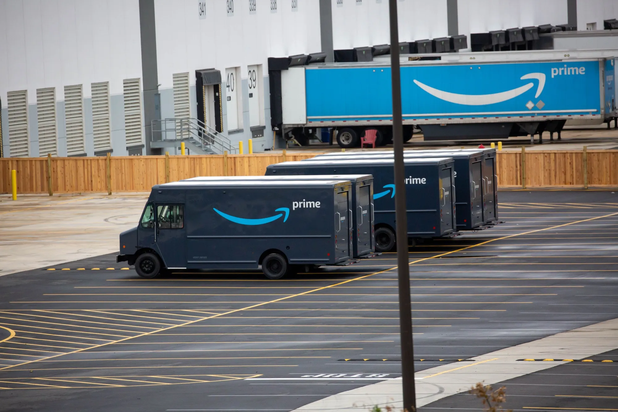 Amazon and trailers are parked outside of a delivery station.