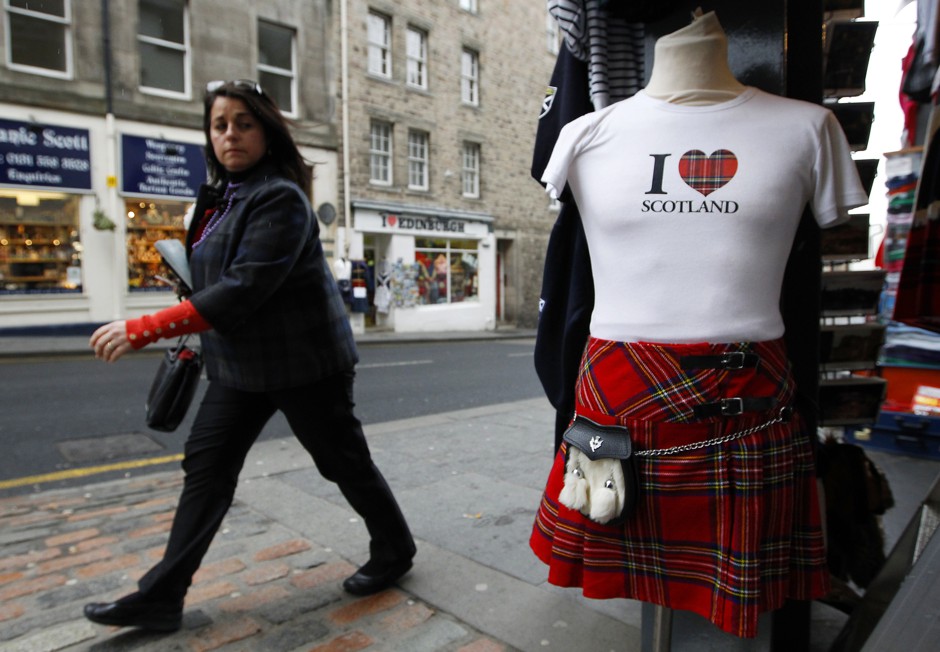 A woman walks past a tourist shop on Edinburgh's Royal Mile.