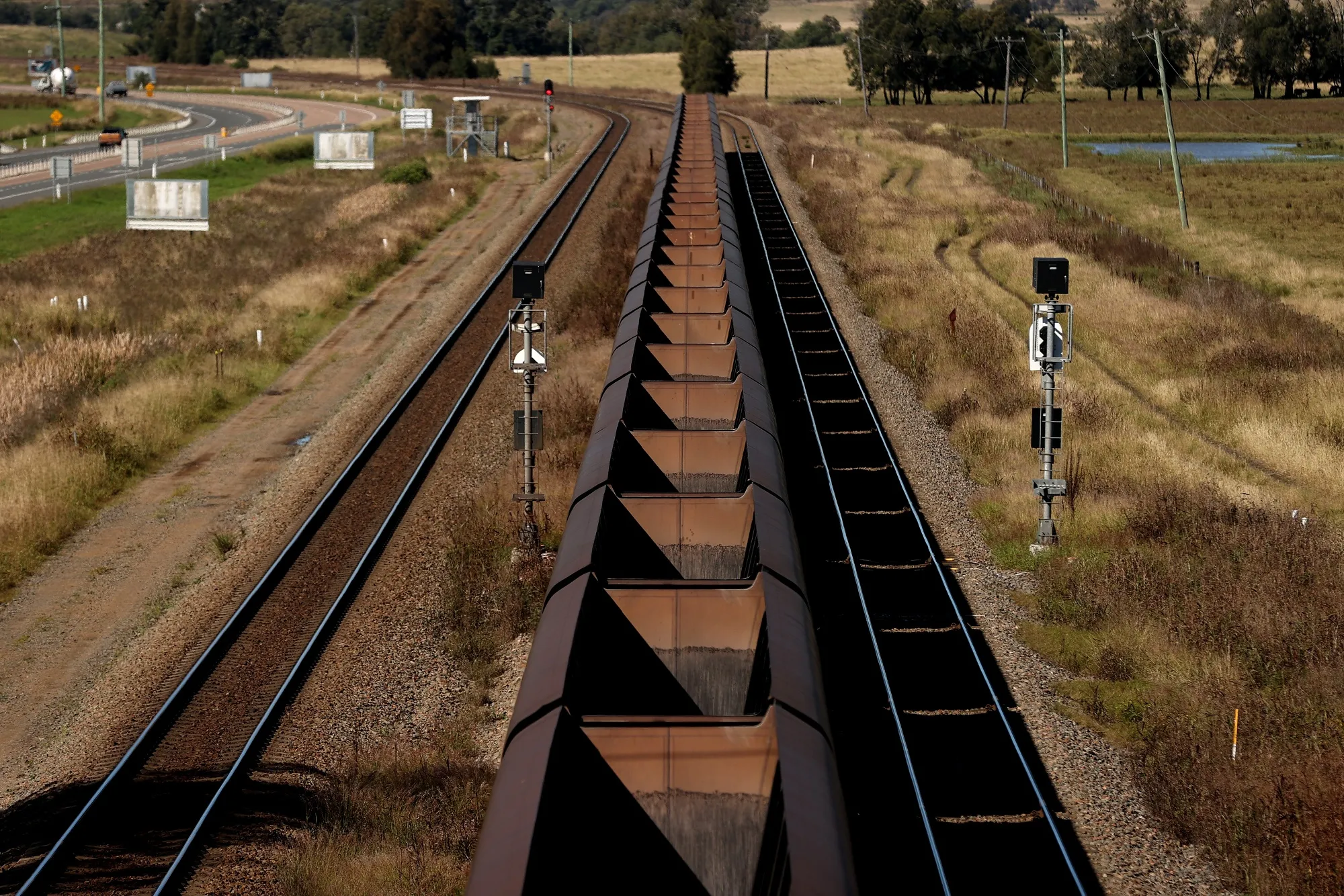 An empty coal train heads towards the coal mines outside of Singleton, New South Wales, Australia.