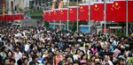 Shoppers and tourists crowd down Nanjing Road East, the city's main shopping street, during the national day golden week in Shanghai, China on Saturday, 01 October, 2011.
